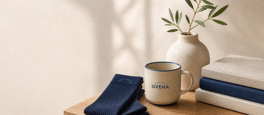 Folded navy compression socks beside a branded mug